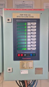 Omicron pump room gas detection alarm system panel displaying HC, H2S, and oxygen readings after calibration and health check on board a ship.