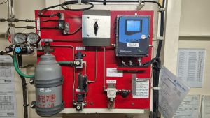 Oxus OA-Z-IG oxygen analyzer system installed onboard, shown during calibration and full function health check with gas regulation and sampling components, serviced at ports including Algeciras, Gibraltar, Huelva, Cartagena, Barcelona, and Bilbao.